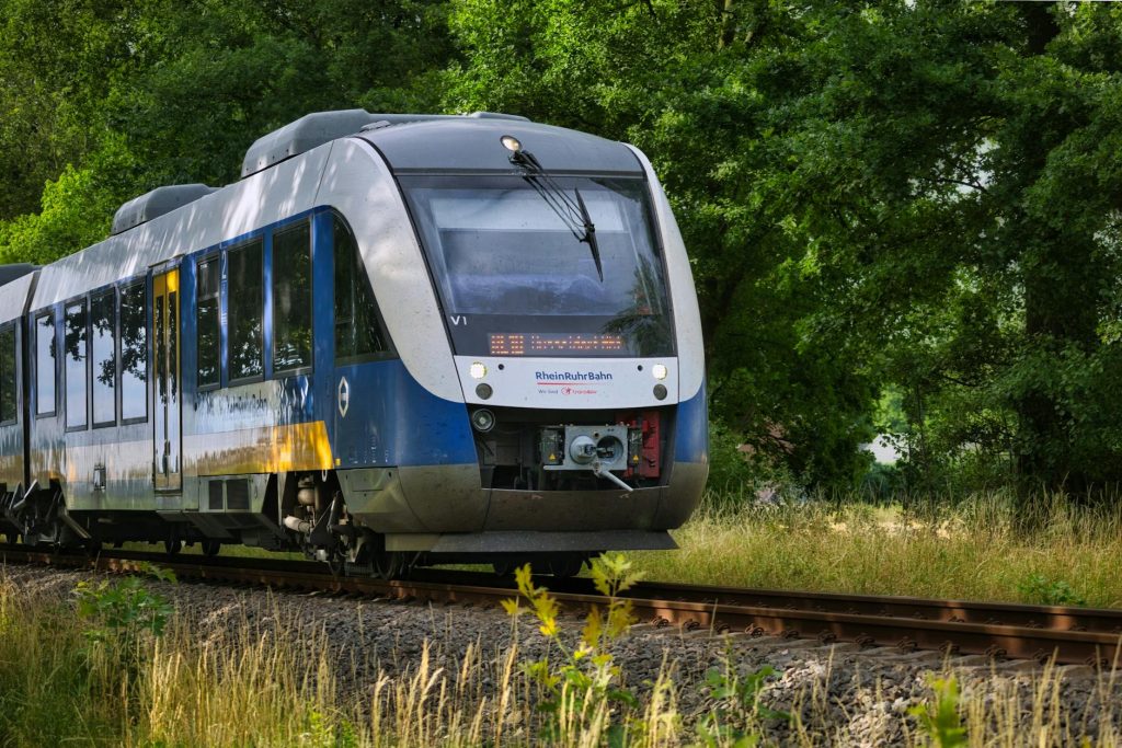 modern train traveling through lush greenery